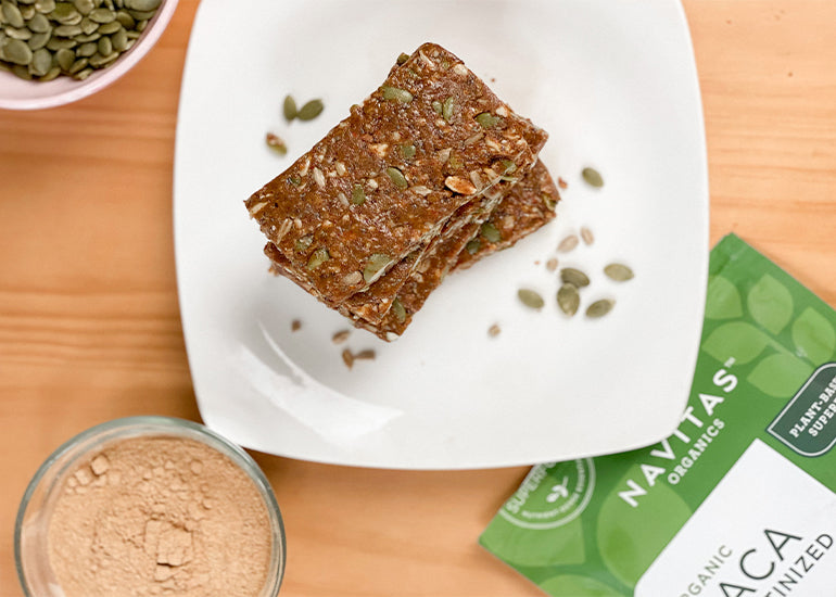 A plate stacked with maca energy bars made with Navitas Organics Gelatinized Maca Powder and Chia Seeds.