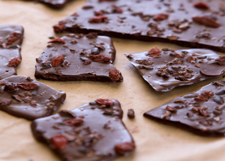 Pieces of dark chocolate bark made with Navitas Organics Cacao Butter Wafers.