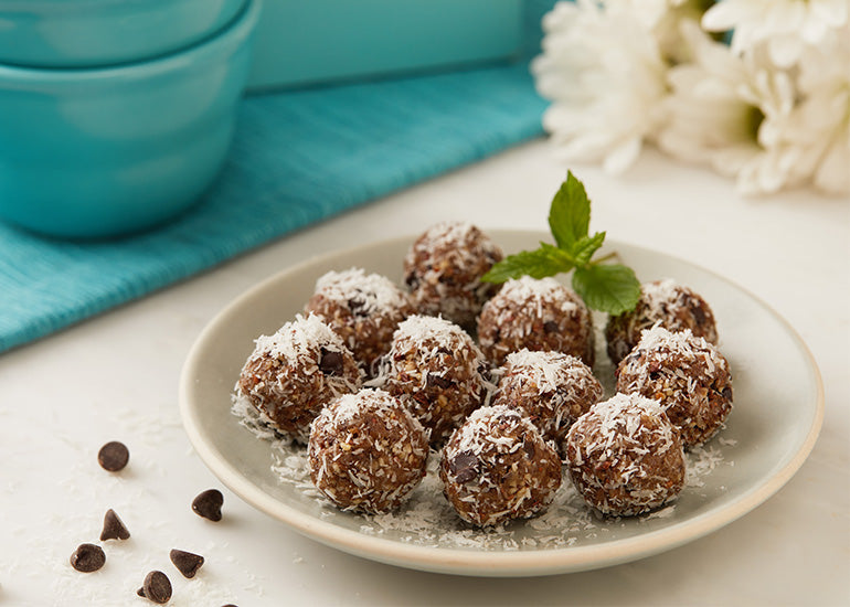 A plate of mint chip protein balls made with Navitas Organics Cacao & Greens Essential Blend Protein Powder and Cacao Nibs.