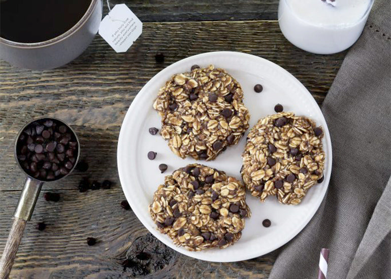 A plate of no-bake oatmeal chocolate chip cookies made with Navitas Organics Cacao Powder and Cacao & Greens Essential Blend Protein Powder.