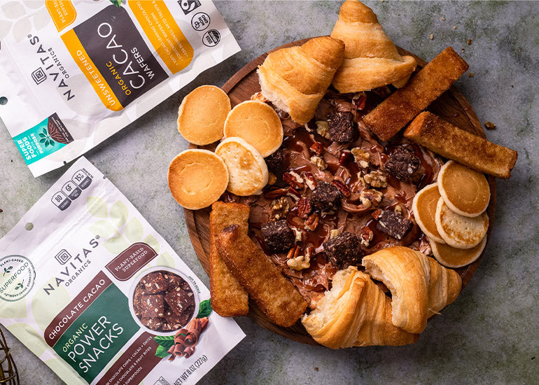 A chocolate butter board made with Navitas Organics Cacao Wafers and Chocolate Cacao Power Snacks.