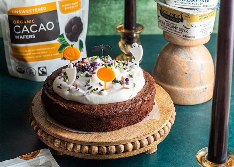 A flourless chocolate cake made with Navitas Organics Cacao Wafers and Cacao Powder, topped with Icelandic Provisions Vanilla Bean Skyr. 