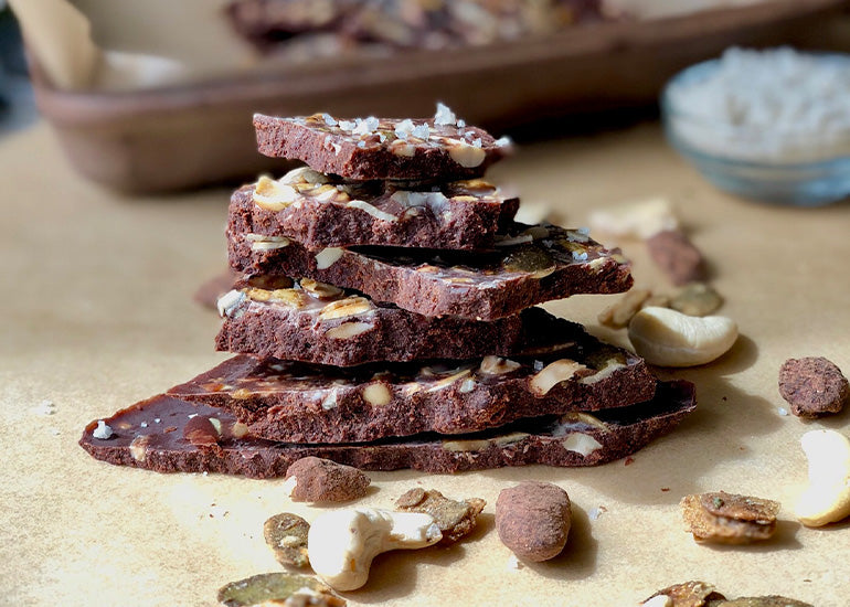 A stack of cacao butter bark with nuts made with Navitas Organics Cacao Powder and Cacao Butter.