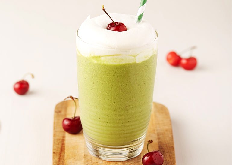 Creamy greens smoothie with cherries made with Navitas Organics Mulberries and Essential Blend Vanilla & Greens 