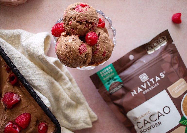 A bowl of chocolate raspberry cottage cheese ice cream made with Navitas Organics Cacao Powder.