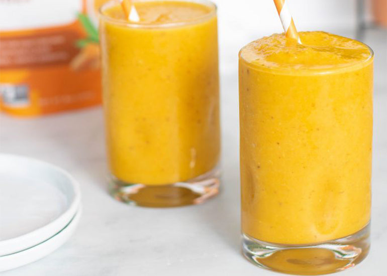 Two vibrant orange smoothies made with Navitas Organics Turmeric Powder