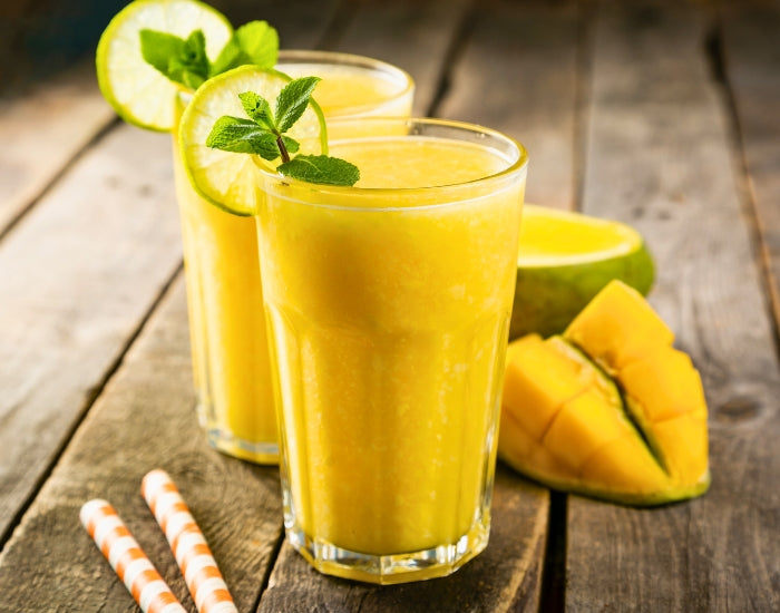 Glass of superfood smoothie with a slice of lime made with Navitas Organics Superfood+ Greens Blend