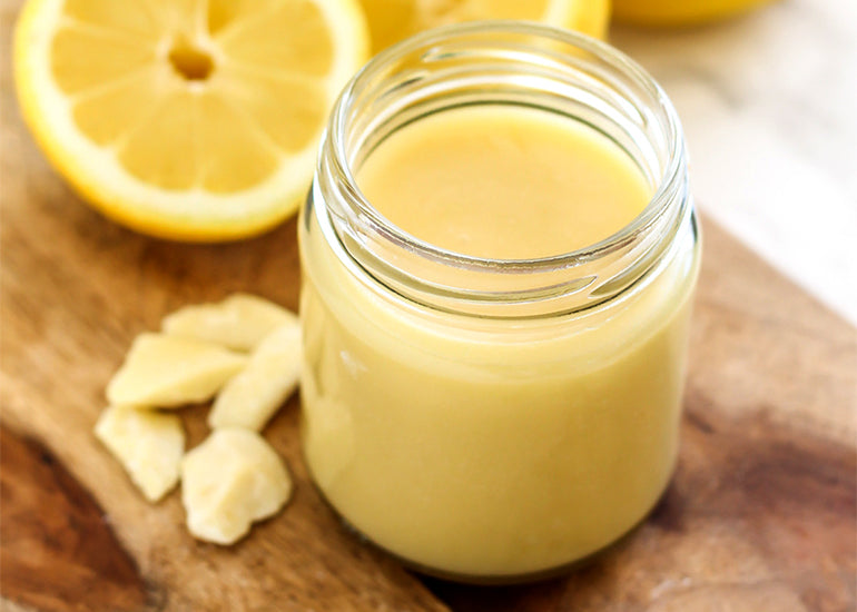 A mason jar filled with lemon vanilla body butter made with Navitas Organics Cacao Butter.