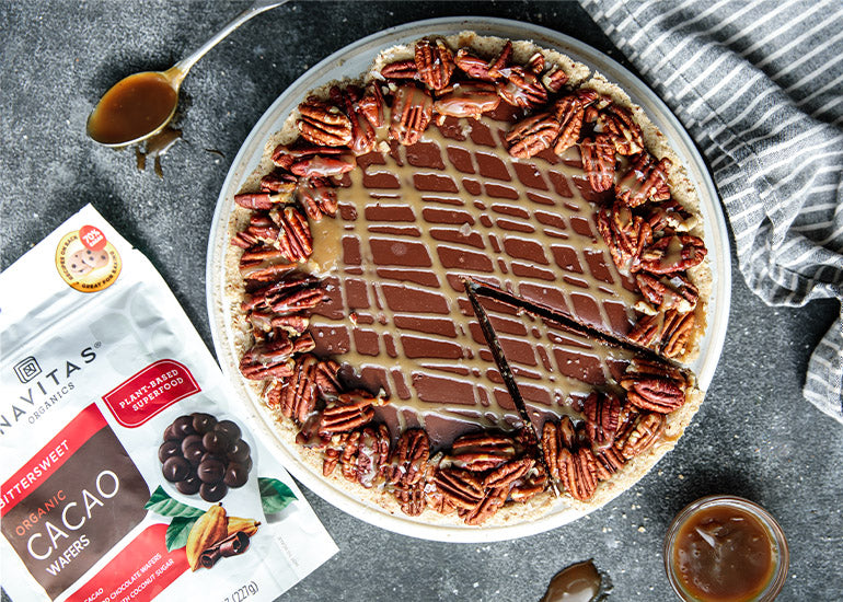 A gluten-free chocolate turtle tart made with Navitas Organics Bittersweet Cacao Wafers.