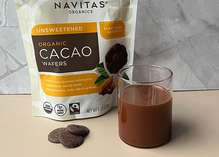 A glass jar filled with a chocolate hazelnut spread made with Navitas Organics Cacao Wafers.