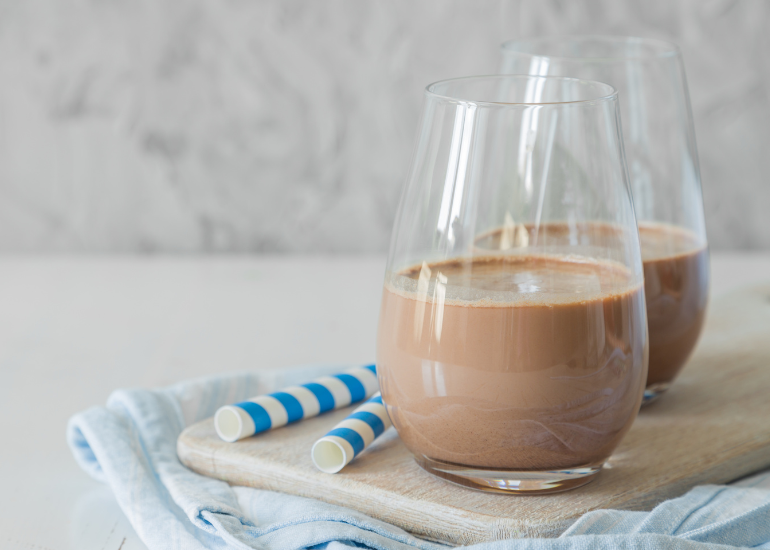 Two glasses of gluten-free dairy-free creamy, chocolate shake made with Navitas Organics Cacao Powder