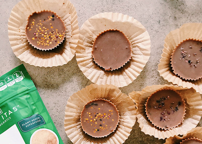 Tahini maca chocolate cups made with Navitas Organics Cacao Butter, Maca Powder and Cacao Nibs, topped with bee pollen