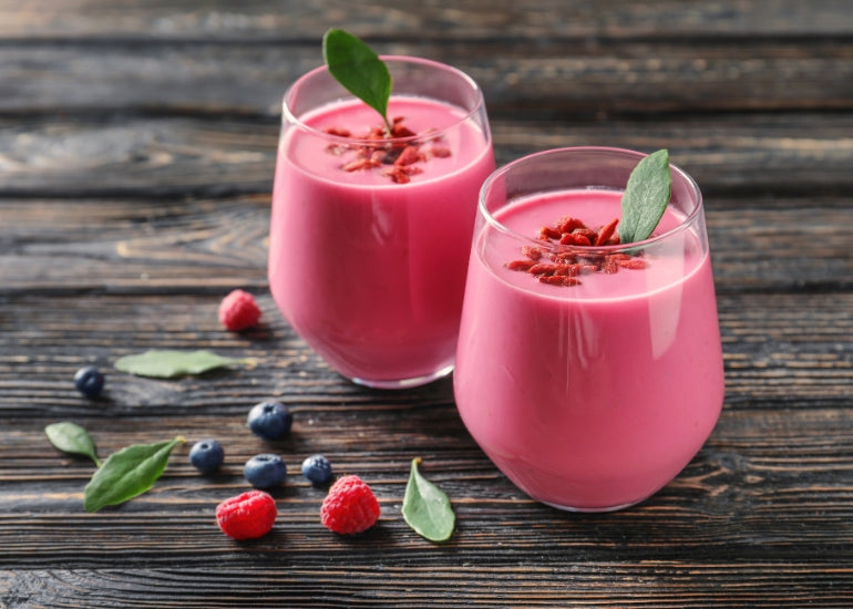 Two glasses filled with a goji berry smoothie made with Navitas Organics Goji Berries