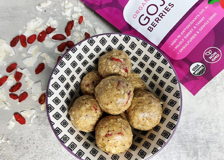 A bowl filled with homemade energy balls, crafted with Navitas Organics Goji Berries