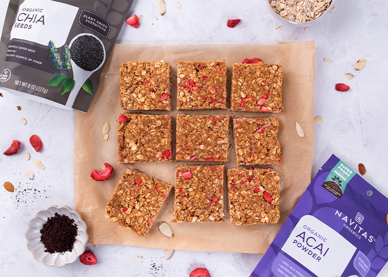 Parchment paper topped with cut up homemade granola bars made with Navitas Organics Acai Powder and Chia Seeds