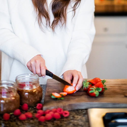 Certified Health Coach Holly Krack preparing berry overnight oats with Navitas Organics superfoods in her kitchen