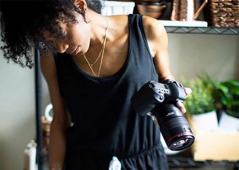 Cook, baker, food stylist, recipe developer and writer Shanika Graham-White with a camera in her hand.