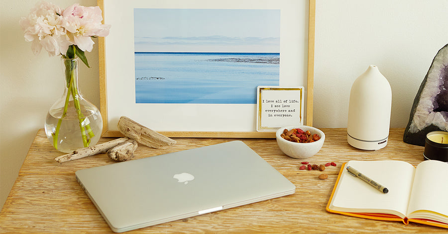 A home office setup with a bowl of Navitas Organics Goji Berries on the desk.