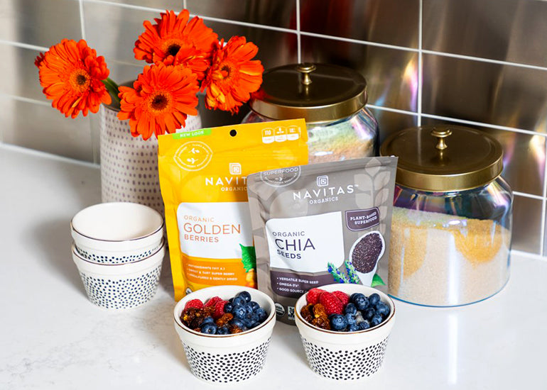 Two dishes filled with chia pudding made with Navitas Organics Chia Seeds, topped with fresh berries and Navitas Organics Goldenberries.