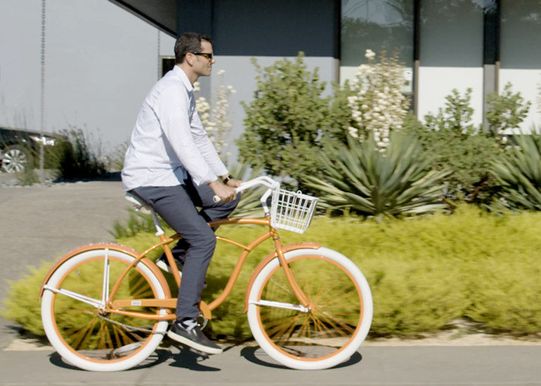 Navitas Organics Founder and CEO, Zach Adelman, riding a bicycle in front of Navitas Organics headquarters in Novato, California.