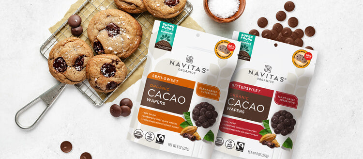 Navitas Organics Semi-sweet and Bittersweet Cacao Wafers with a baking rack filled with chocolate chip cookies