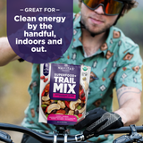Navitas Organics Superfood+ Trail Mix Antioxidant Blend package held by a person on a bike with promotional text.