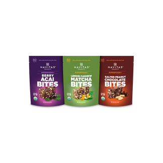 Three Navitas Organics Superfood+ BITES packages including Berry Acai, Lemon Cashew Matcha and Salted Peanut Chocolate BITES.