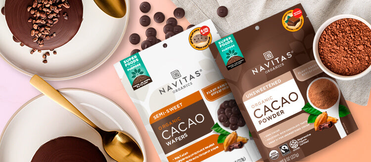 Navitas Organics Cacao Powder and Semi-sweet Cacao Wafers on a light background surrounded by chocolate desserts.