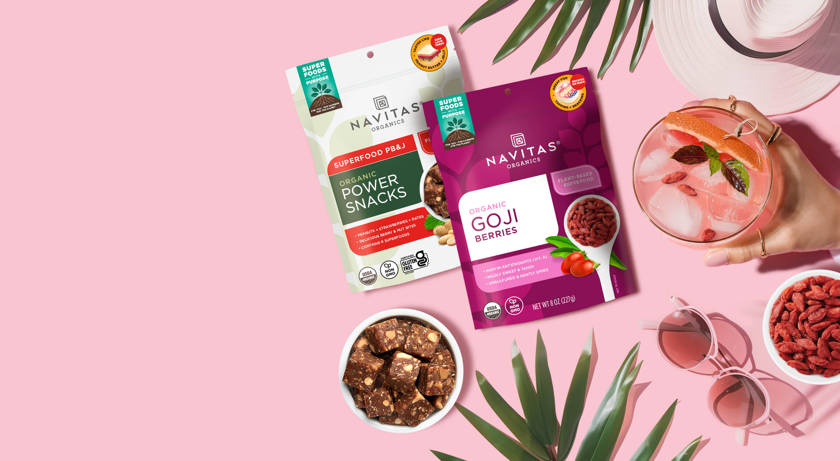 Navitas Organics PB&J Power Snacks and Goji Berries with summer accessories and an iced drink