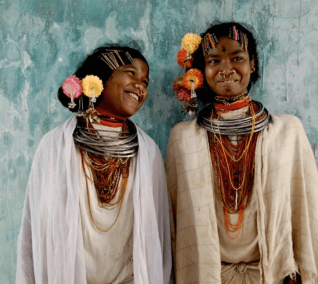 Two girls from Sierra Leone in local dress smiling.