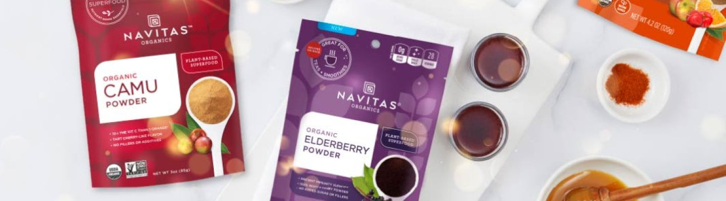 Navitas Organics Camu and Elderberry packages on a table of food