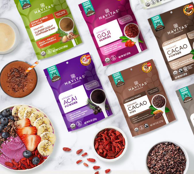 A variety of Navitas Organics superfoods, a smoothie bowl, smoothie and latte